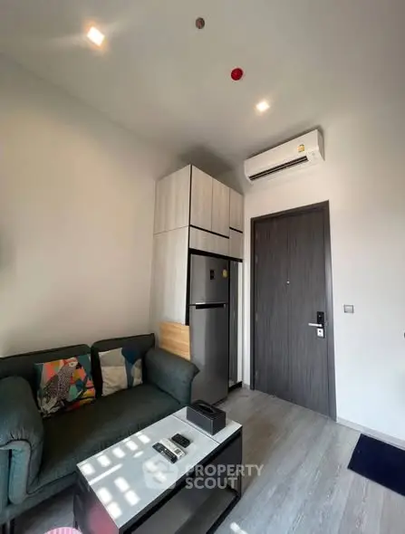 Modern living room with sleek furniture and air conditioning in a stylish apartment.