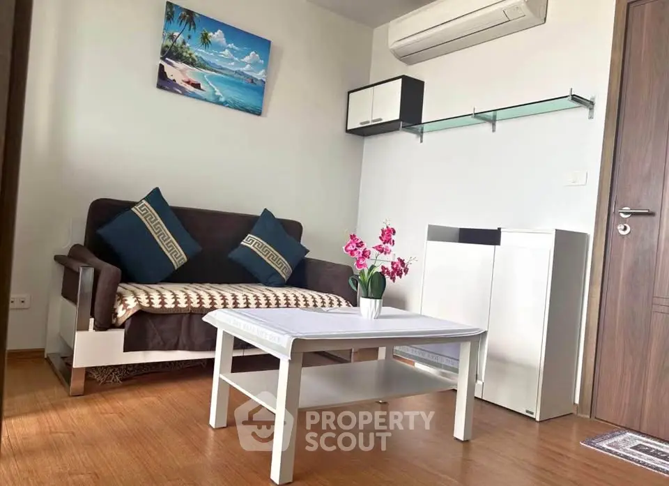 Charming living room with cozy sofa, modern decor, and air conditioning in a stylish apartment.