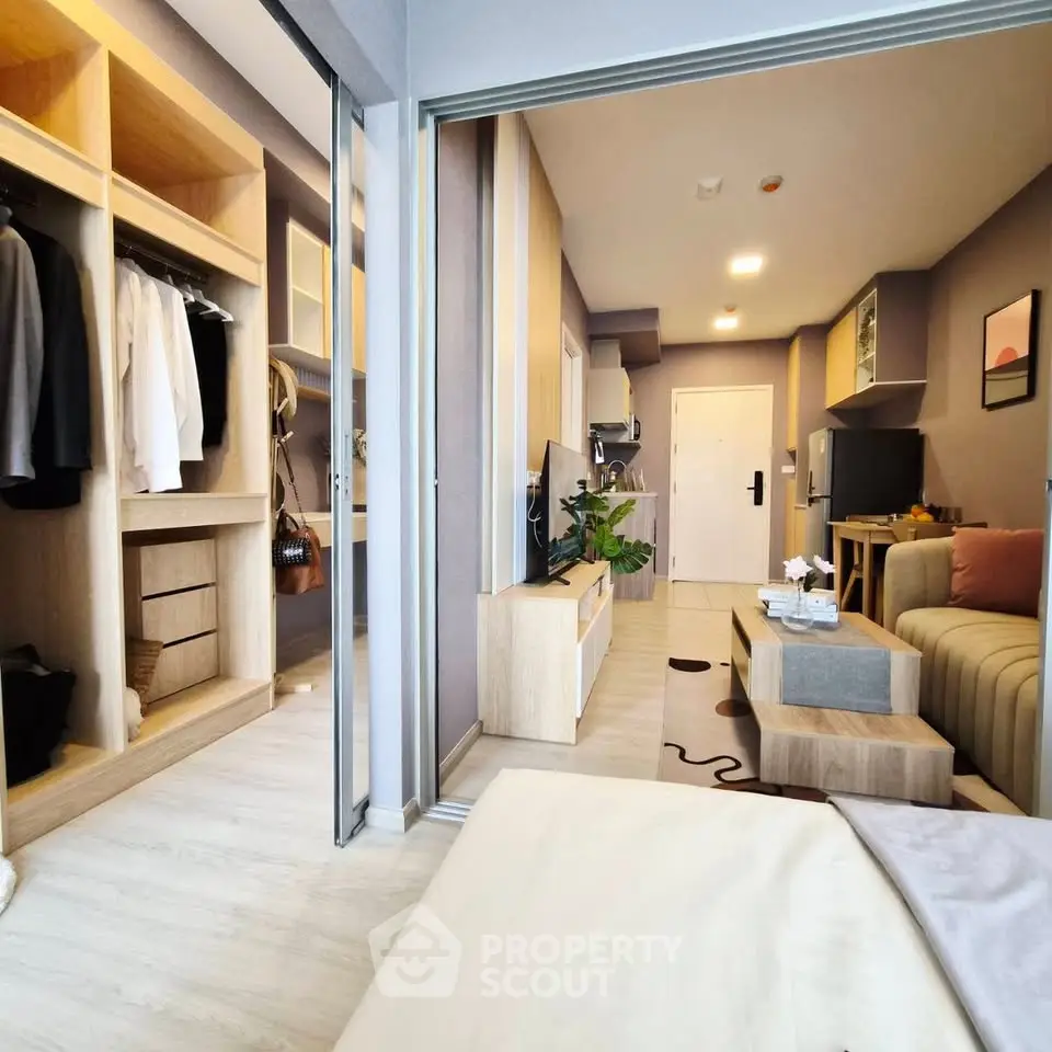 Modern open-plan apartment with stylish living area and spacious walk-in closet, perfect for urban living.