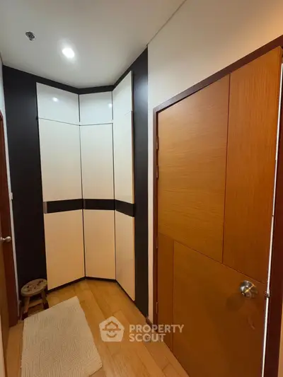 Modern hallway with sleek storage cabinets and wooden doors