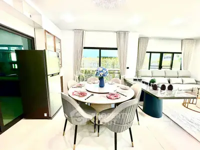 Elegant open-plan living and dining area with modern furnishings and natural light.