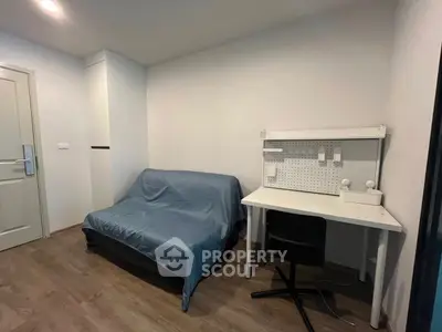 Cozy study room with desk and sofa, perfect for productivity.