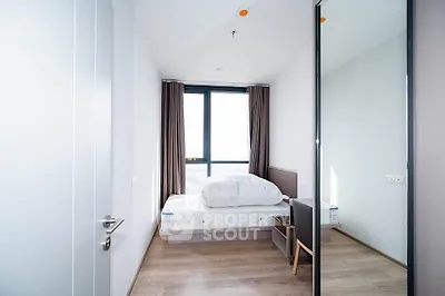 Bright and modern bedroom with large window and minimalist decor