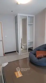 Cozy bedroom with mirrored wardrobe and bean bag chair