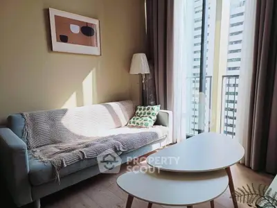Chic living room with modern sofa, stylish coffee table, and balcony view in urban apartment.