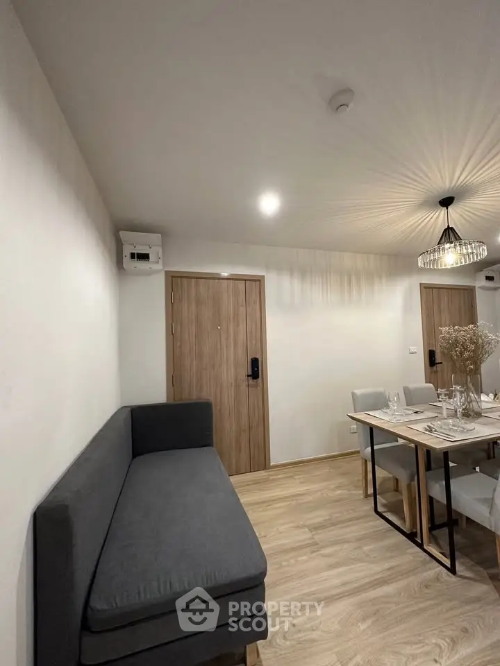 Modern dining area with stylish lighting and cozy seating in a contemporary apartment.