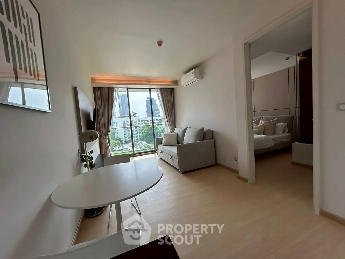 Modern apartment living room with city view and cozy bedroom