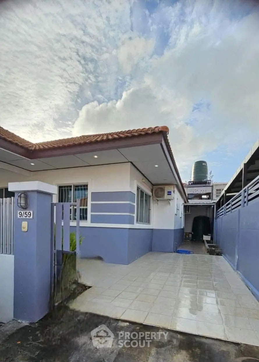 Charming single-story home with tiled driveway and modern exterior design.