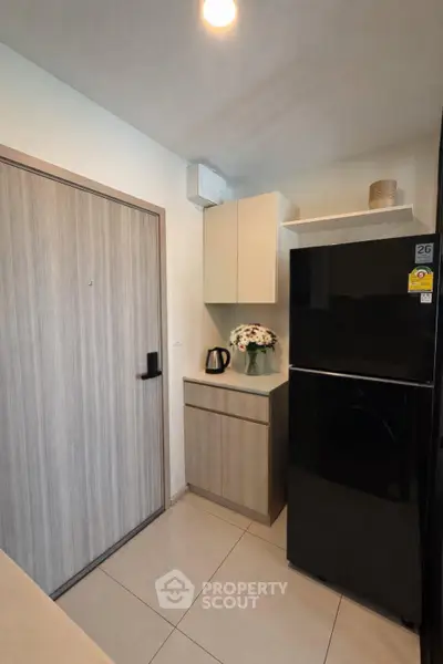 Modern kitchen with sleek black fridge and stylish cabinetry
