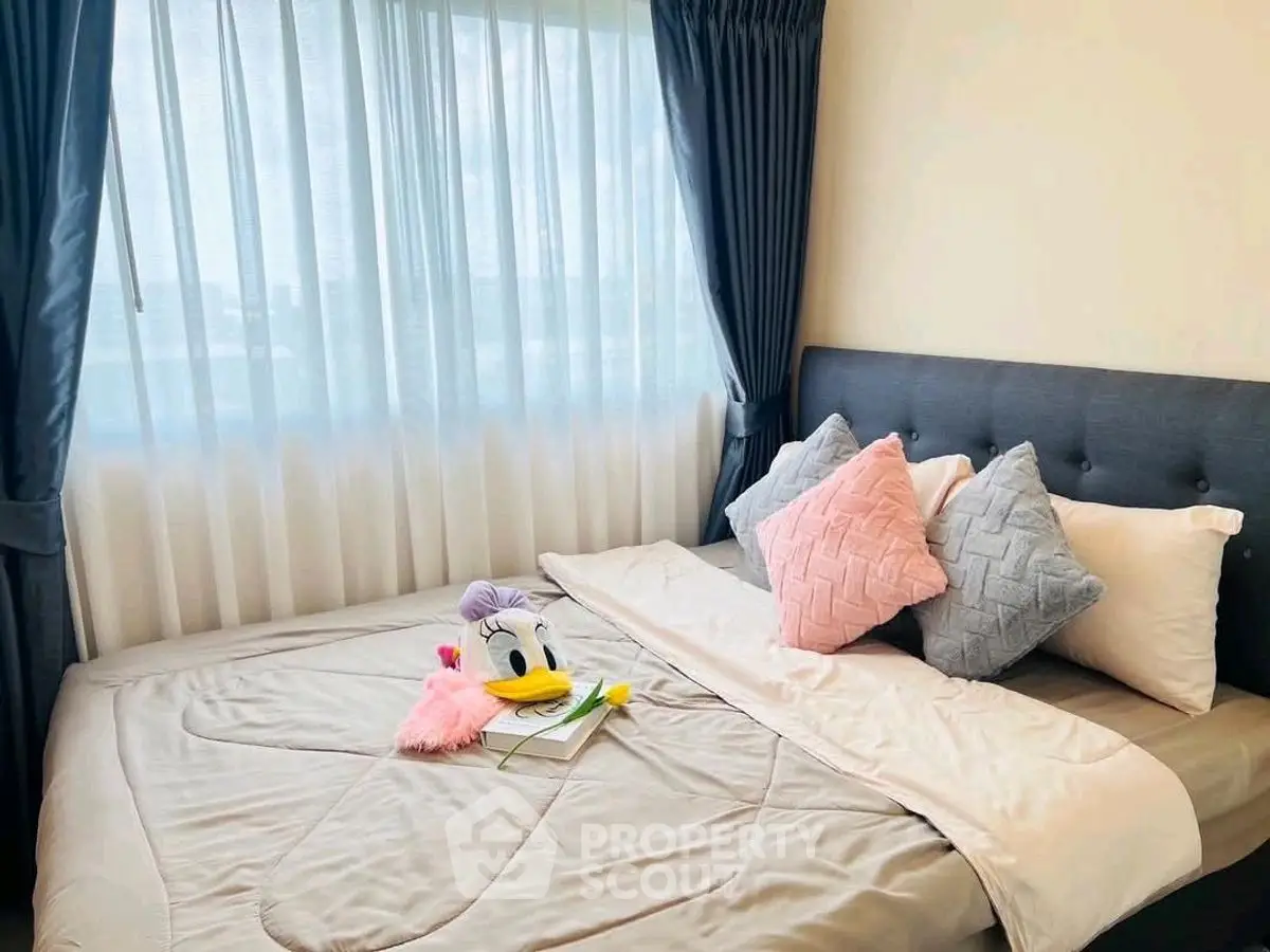 Cozy bedroom with plush pillows and soft lighting, perfect for relaxation.