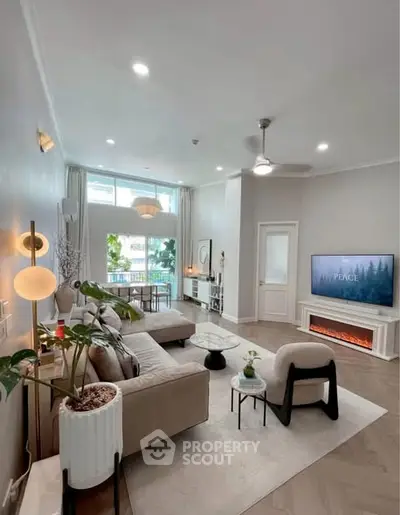 Spacious modern living room with elegant decor and large windows offering natural light.