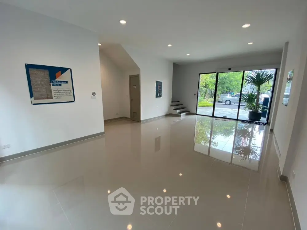 Spacious modern living room with glossy floors and large windows
