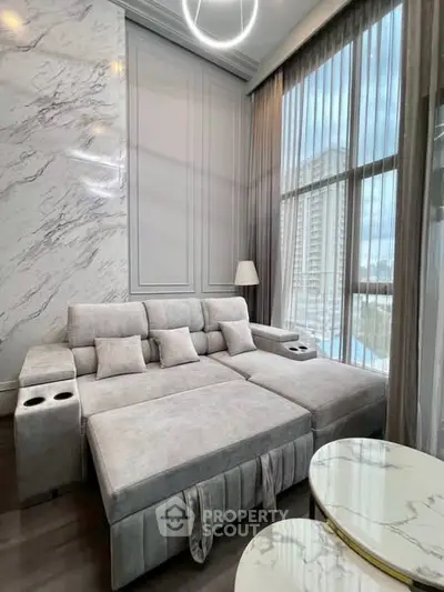 Luxurious modern living room with marble accents and large windows offering stunning city views.