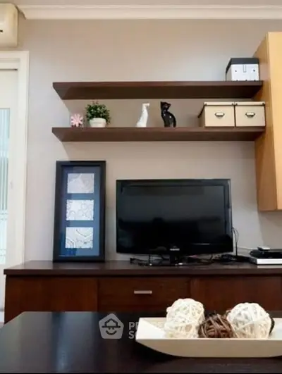 Modern living room with sleek TV setup and stylish shelving