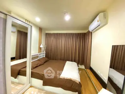Cozy bedroom with mirrored wardrobe and air conditioning in modern apartment