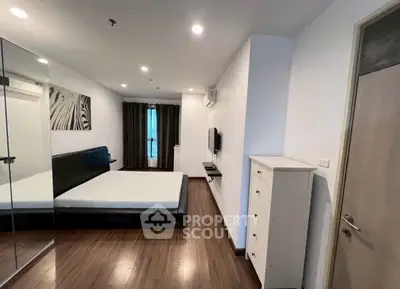 Spacious modern bedroom with sleek design and ample natural light