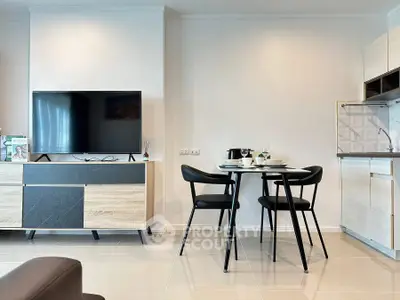 Modern living room with sleek furniture and dining area in open layout.