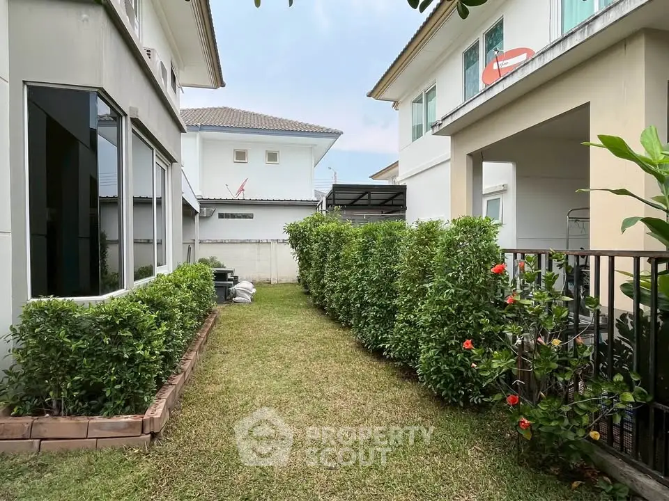 Charming suburban backyard with lush greenery and modern house exteriors, perfect for family living.