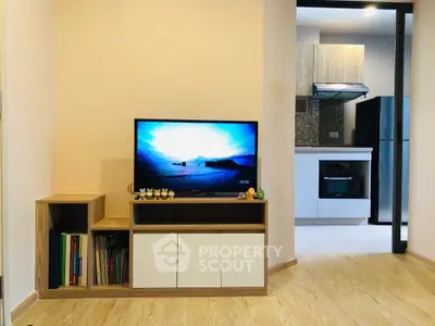 Modern living room with TV and open kitchen layout in stylish apartment