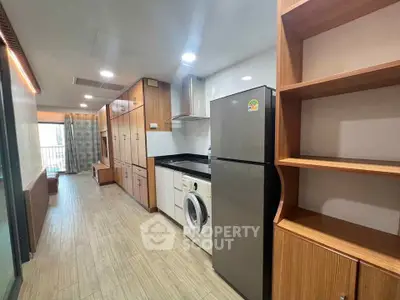 Modern kitchen with sleek appliances and ample storage in a stylish apartment