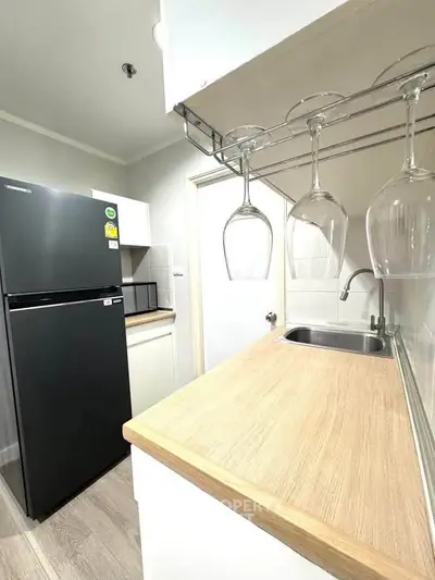 Modern kitchen with sleek black fridge and stylish glass rack