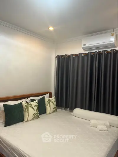 Cozy bedroom with elegant decor and air conditioning, perfect for relaxation.
