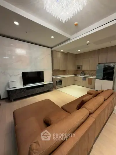 Luxurious open-layout kitchen and living room with modern appliances and elegant decor.