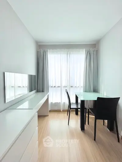 Bright minimalist living room with sleek furniture and ample natural light, perfect for modern living.
