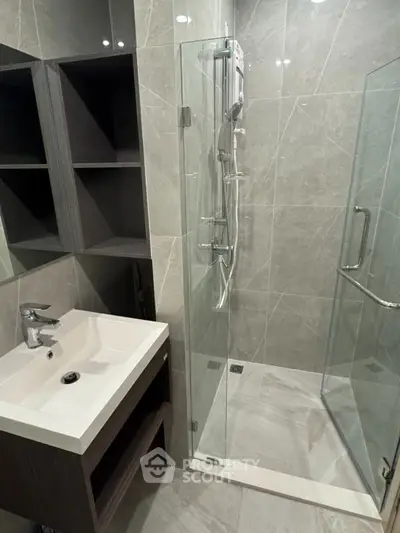 Modern bathroom with sleek shower and stylish vanity in contemporary design.