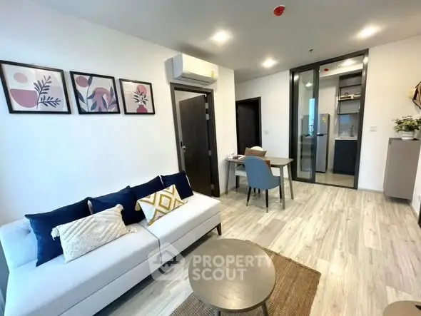 Modern living room with stylish decor and open kitchen layout in a contemporary apartment.