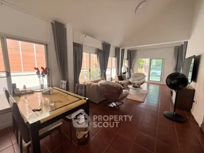 Spacious living room with modern decor and large windows for natural light
