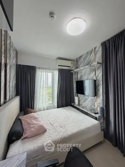 Modern bedroom with stylish decor and natural light