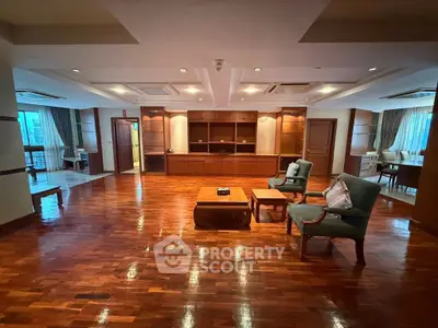 Spacious living room with elegant wooden flooring and classic furniture