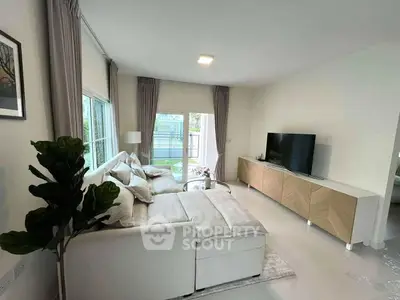 Spacious modern living room with large windows and elegant decor