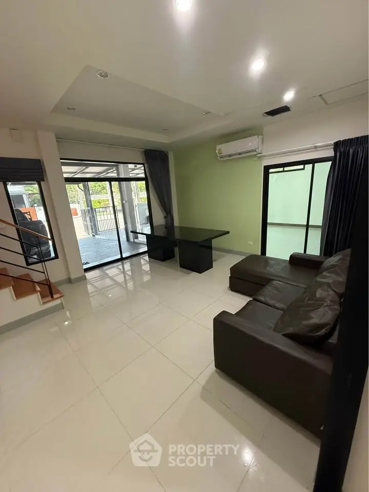 Spacious living room with modern furniture and large windows for natural light.