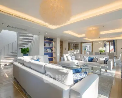 Luxurious open-plan living room with elegant decor and modern lighting