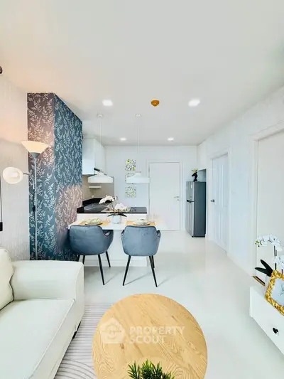 Modern open-plan living room with stylish kitchen and dining area, featuring elegant decor and contemporary furniture.