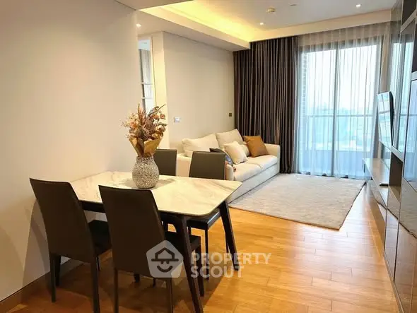 Modern living room with elegant dining area and large windows.