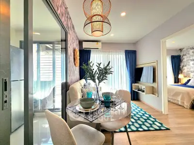 Modern living room with stylish decor and open layout leading to a cozy bedroom, perfect for urban living.