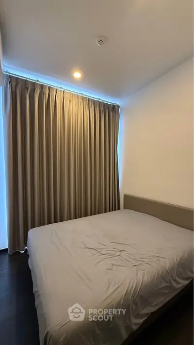 Cozy bedroom with elegant curtains and soft lighting, perfect for restful nights.