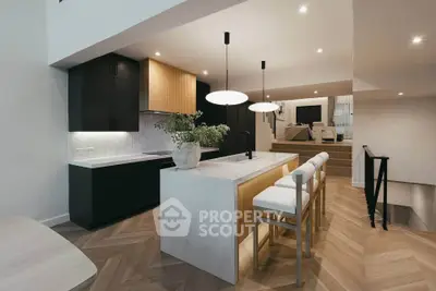 Modern open-layout kitchen with sleek design and stylish lighting in a contemporary home.