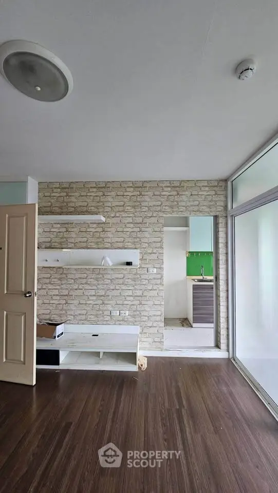Modern living room with stone accent wall and open kitchen layout