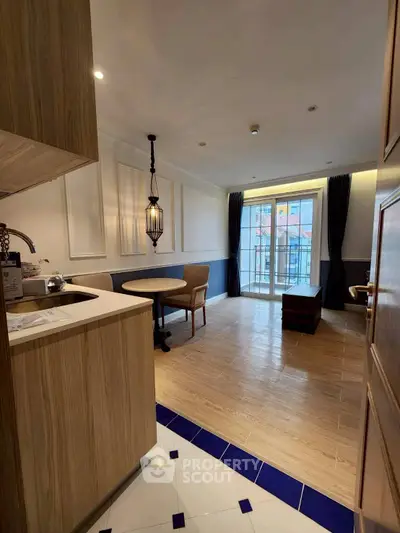 Charming open-layout living room with elegant decor and natural light, perfect for modern living.