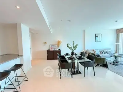 Spacious modern living and dining area with elegant decor and natural light.