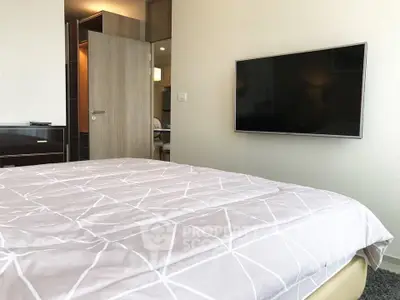 Modern bedroom with wall-mounted TV and stylish decor