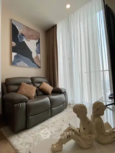 Cozy living room with modern decor and large window for natural light