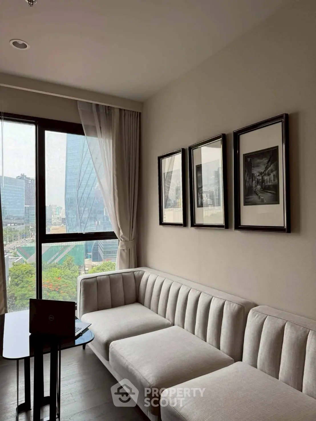 Modern living room with elegant sofa and city view from large window