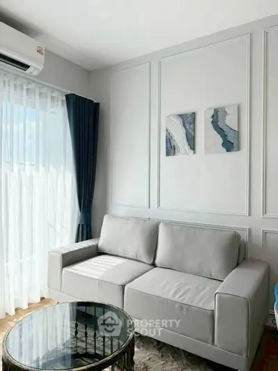 Modern living room with elegant gray sofa and natural light