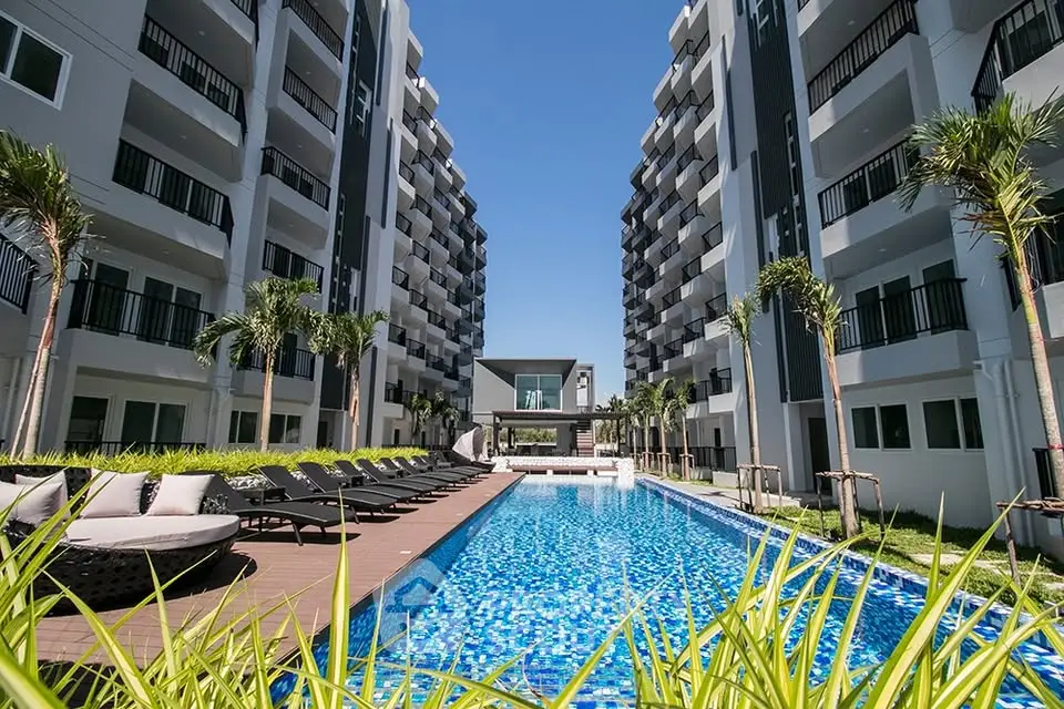 Luxurious apartment complex with stunning pool and modern architecture.
