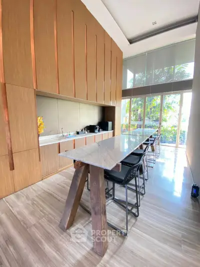Luxurious modern kitchen with sleek design and large windows offering natural light.